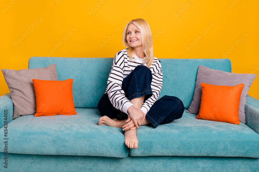 Photo of positive senior lady grandmother sitting comfy divan look furniture shop adverts isolated vivid color background Photo of positive senior lady grandmother sitting comfy divan look furniture shop adverts isolated vivid color background