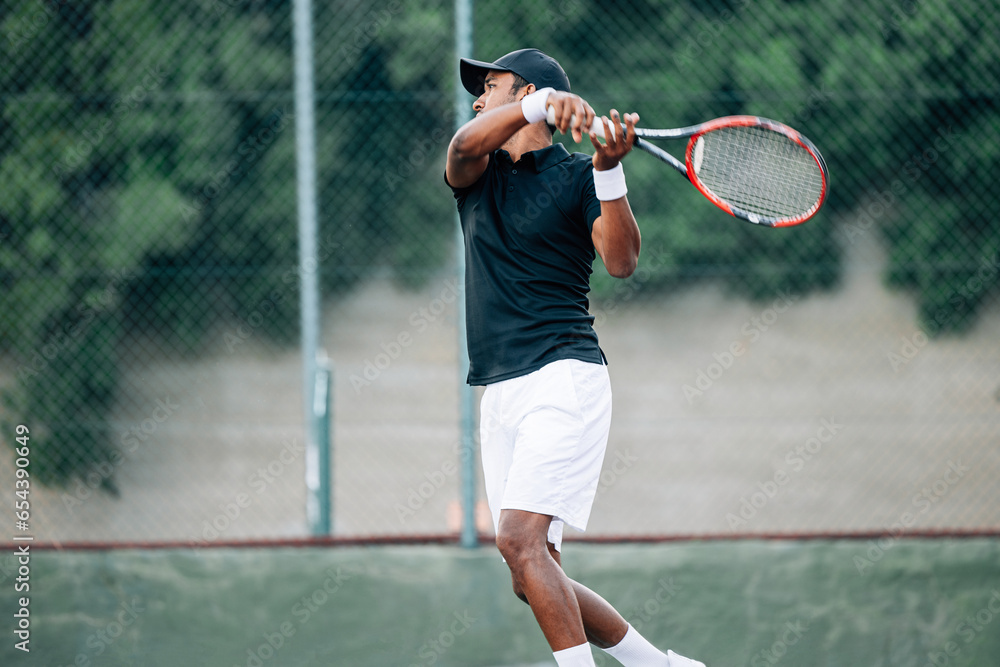 Side view of a professional tennis player returning the serve