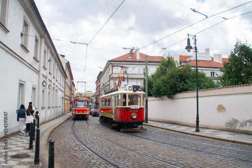 Red trams passing on Letenska street. Prague, Czech Republic