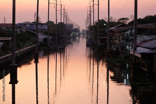 The atmosphere of the wooden houses along the canal in Bangkok in the evening looks as far as the eye can see.