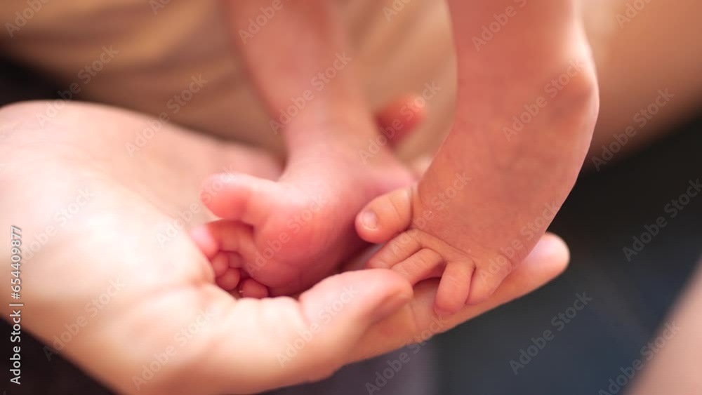 mother holding baby newborn feet. friendly family kid dream concept. mothers day concept. baby newborn in mother arms close-up of lifestyle legs mother holding baby newborn feet. friendly family kid dream concept. mothers day concept. baby newborn in mother arms close-up of lifestyle legs