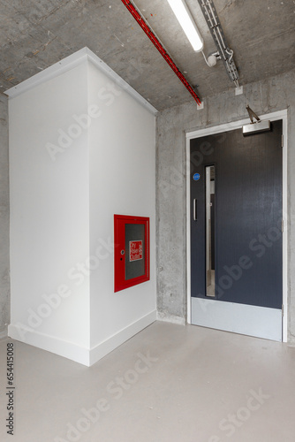 Fire exit sign with light on the path way in the commercial building