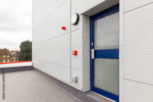 Fire exit sign with light on the path way in the commercial building