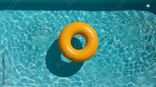Yellow pool float in the swimming pool photo