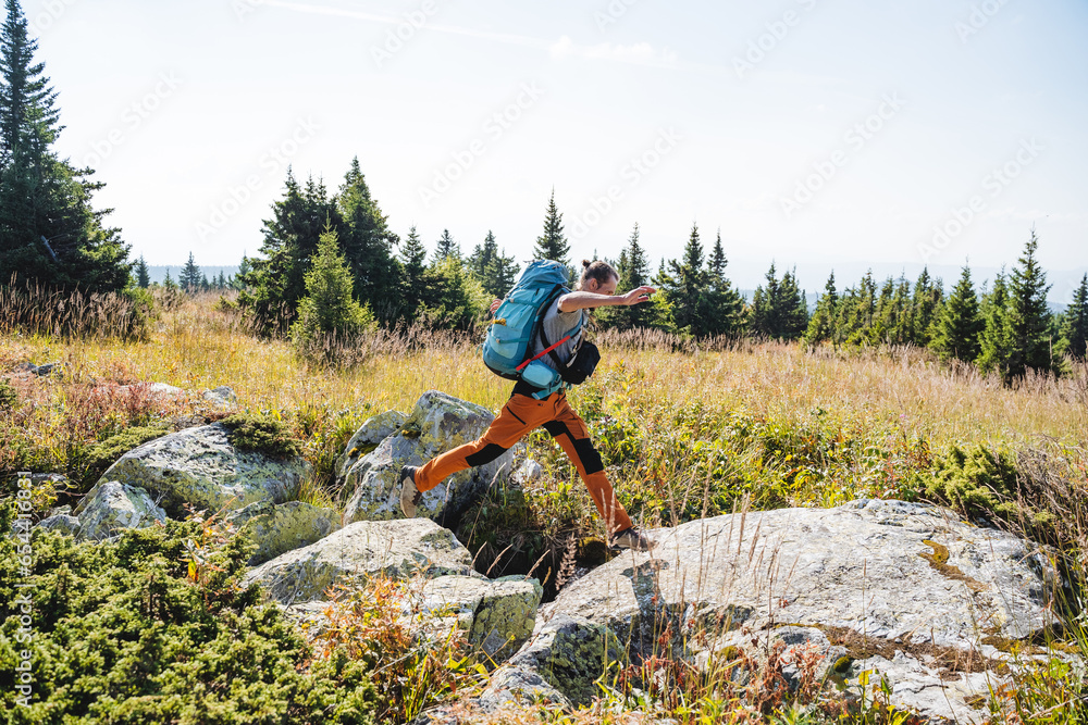 Vacation in the mountains, traveling with a backpack on your back, mountain trekking alone, overcoming obstacles on the way, large stones under your feet. Vacation in the mountains, traveling with a backpack on your back, mountain trekking alone, overcoming obstacles on the way, large stones under your feet.