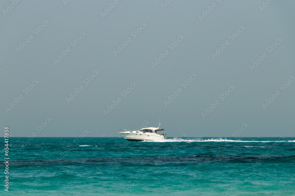 Blue clear sea, yacht, water, waves, clear sky. beach in Saadiyat island, United Arab Emirates. Beautiful seascape.