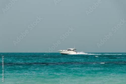 Blue clear sea, yacht, water, waves, clear sky. beach in Saadiyat island, United Arab Emirates. Beautiful seascape.