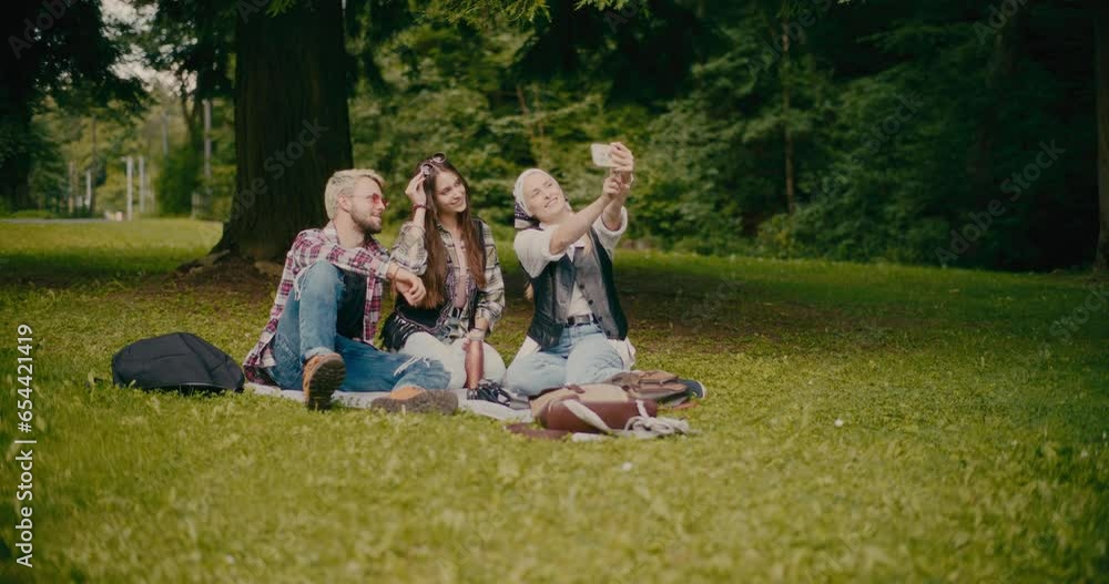 Woman Taking Selfie With Friends At Park Woman Taking Selfie With Friends At Park