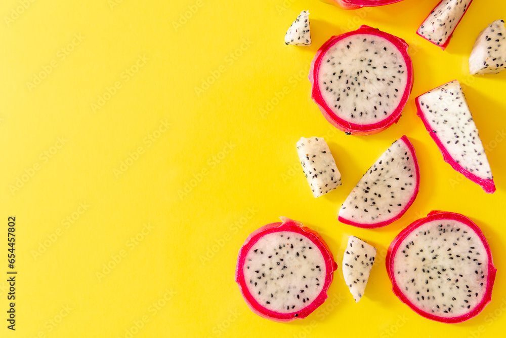 Slices of fresh white pitaya or dragon fruit on yellow background, flat lay Slices of fresh white pitaya or dragon fruit on yellow background, flat lay