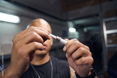 Quadro em tela African American worker of service station holding in hands sparking plug