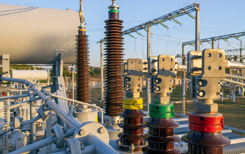 Converter transformer with ceramic insulators and bushings at a substation.