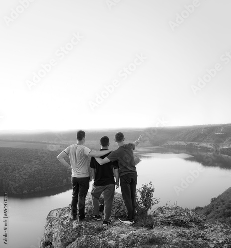 Three friends look at the valley