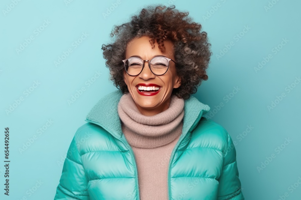 Senior afroamerican woman in warm winter outfit over blue background. Healthy, happy aged lady - obrazy, fototapety, plakaty 