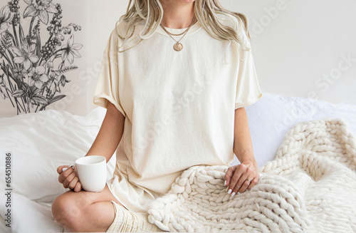 Young girl wearing blank oversized soft cream, ivory t shirt mock up , for home boho designs. Cream colors tshirt for your design