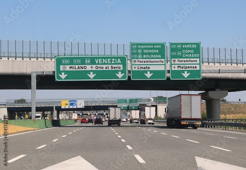motorway junction with directions to the Italian cities and road junctions with trucks and cars photo