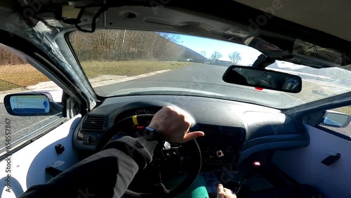 Skilled driver holding dangerous drifting maneuvers on competition playground, man steering wheel and changing gears, feeling adrenaline while drifting