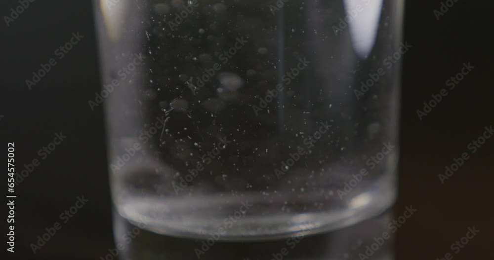 Glass of water with fizzy tablet closeup Glass of water with fizzy tablet closeup