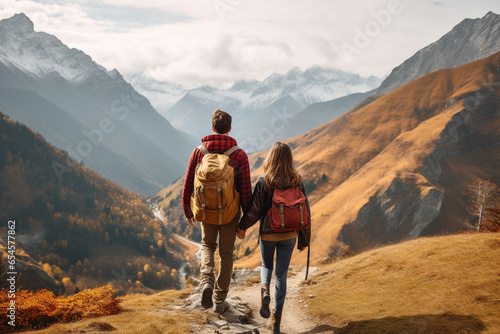 rear view backpacker or hiker or camper, mountains, woman and man on a trip together