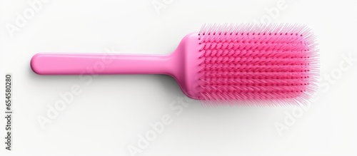 3 dimensional pink brush for childrens hair illustrated in a girls hand against a white background A tool used in a barber shop for hair care services designed as a cute cartoon toy and rep photo