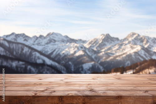 Empty wooden table top with blurred snowy mountain background for product display montage