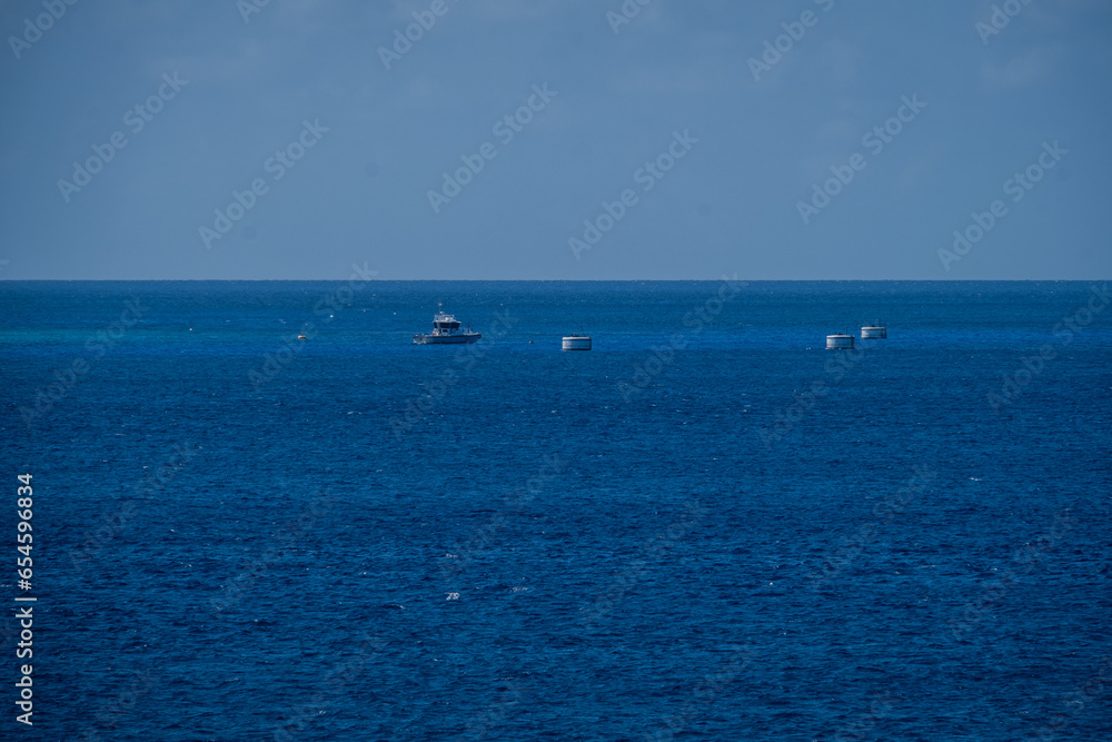 Deep blue sea and traffic at Georgetown port, the Bahamas island on the Caribbean Sea