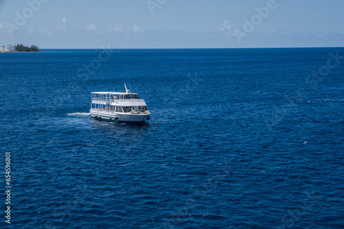 Deep blue sea and traffic at Georgetown port, the Bahamas island on the Caribbean Sea © Kanokwalee