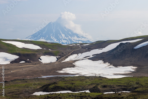 View from Gorely volcano to Vilyuchinsky volcano, Kamchatka Territory, Russia. Mountain landscape. Travel, tourism and hiking on the Kamchatka Peninsula. Beautiful nature of the Russian Far East. photo