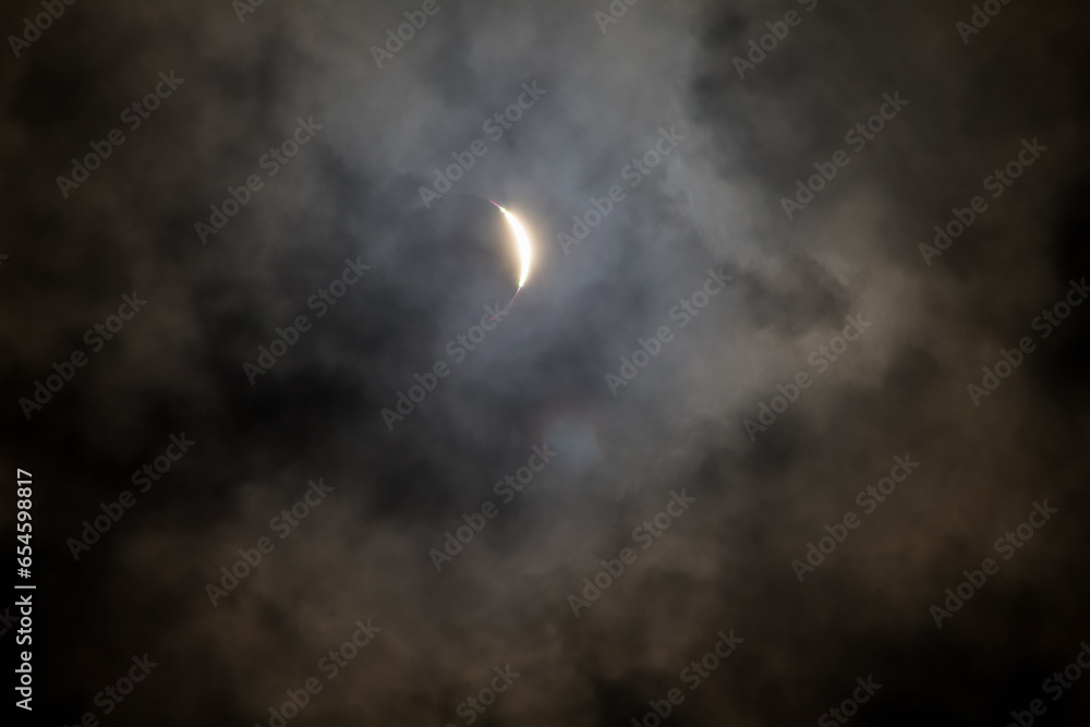 Cloudy solar eclipse