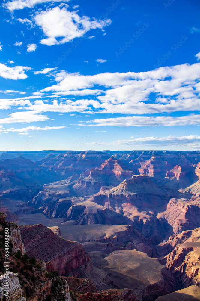 Grand canyon with bright blue sky and white clouds