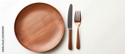 Balanced food with various products seen from above next to cutlery on white background