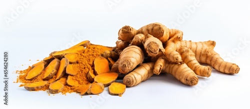 Top view of a pile of organic turmeric root on a white background a macro close up photo