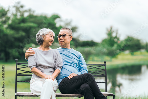 Asian people mature husband and wife, seated on chairs, elderly couple, seated in the park on comfortable chair, deep love and lifelong. Elderly Love Senior Couples, long life togetherness © M+Isolation+Photo