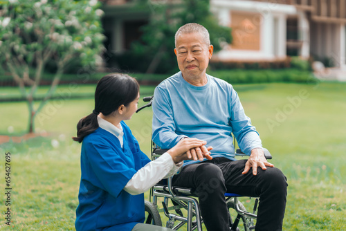 Asian people elderly man on wheelchair with caregiver nurse outdoor    exemplifying the essence of holistic well-being and compassionate support. Nature Therapy