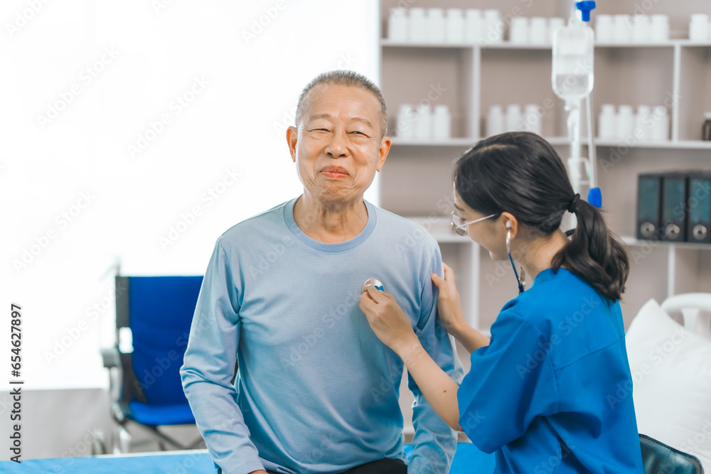Fototapeta premium Elderly man engages in thoughtful discussion with compassionate asian people female doctor, addressing health agenda and medical concerns, exemplifying importance of patient-centered care.