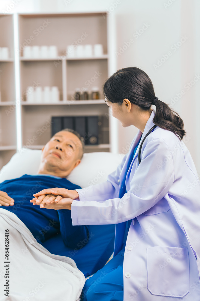 Caring female doctor provides attentive medical care to asian people elderly man lying in hospital bed, highlighting importance of expert healthcare and support during times of illness. Caring female doctor provides attentive medical care to asian people elderly man lying in hospital bed, highlighting importance of expert healthcare and support during times of illness.