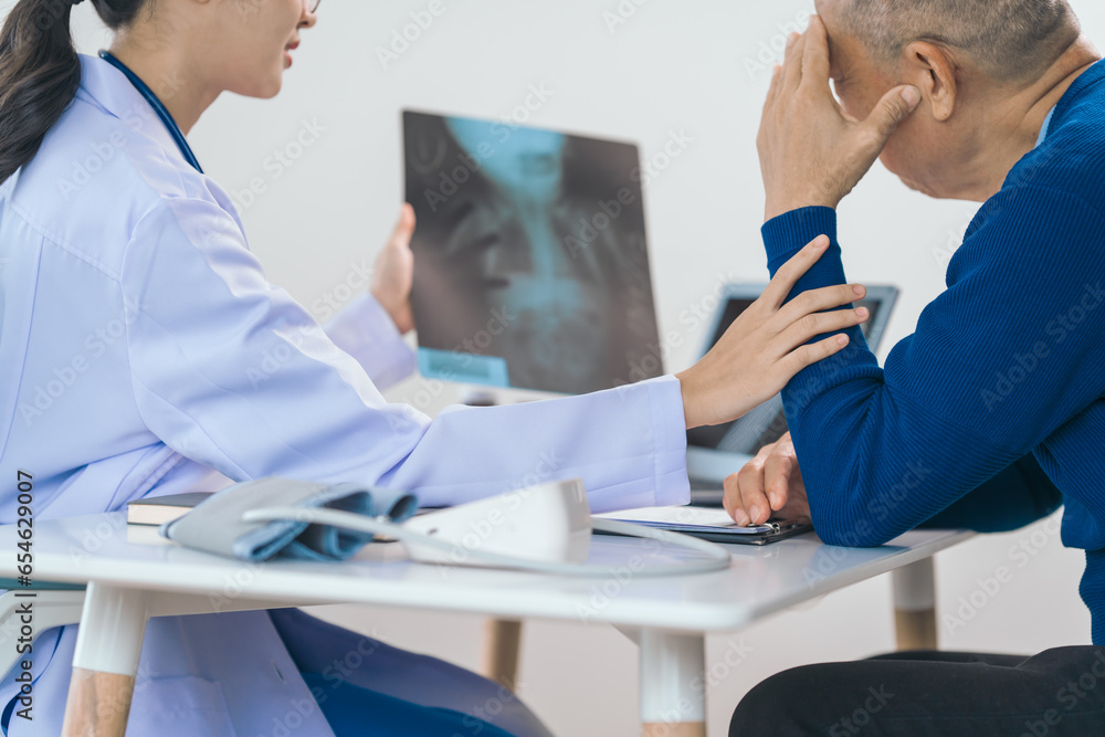 Obraz premium Asian people experienced female doctor giving advice to elderly male patient cancer and x-ray results and treatment options, Cancer Consultation, Elderly Man Receives Expert Cancer Advice Awareness