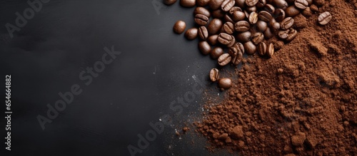 Coffee beans and ground coffee on gray background with blank space above view photo