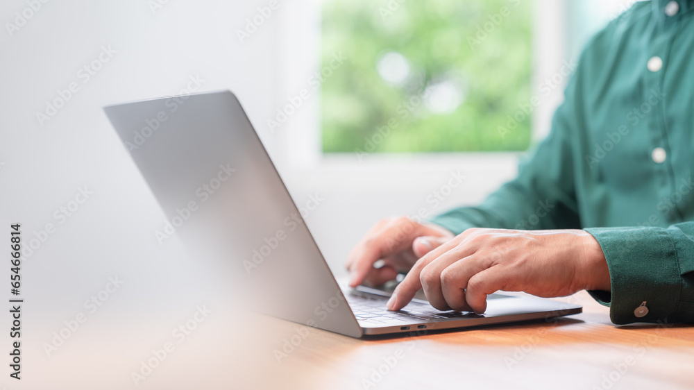 Freelancer use laptop working in late morning. Male hands typing on laptop computer keyboard. Business and technology concept of entrepreneur work, work from home, businessman working at home office. Freelancer use laptop working in late morning. Male hands typing on laptop computer keyboard. Business and technology concept of entrepreneur work, work from home, businessman working at home office.