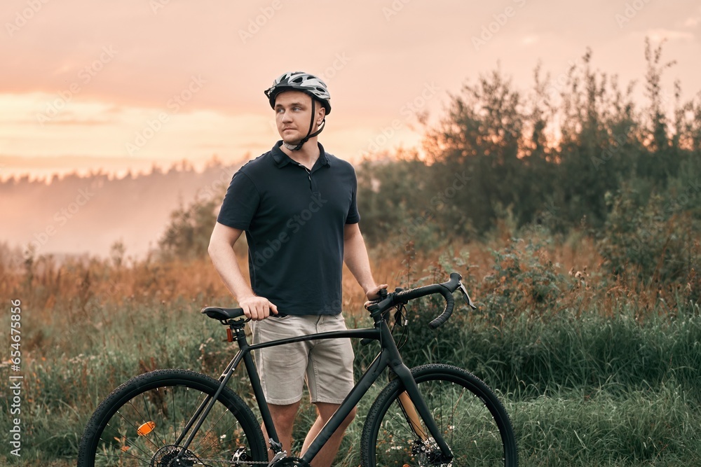 Obraz premium Rider in action at Graveling bike. A man rides a bicycle. Outdoor activity.