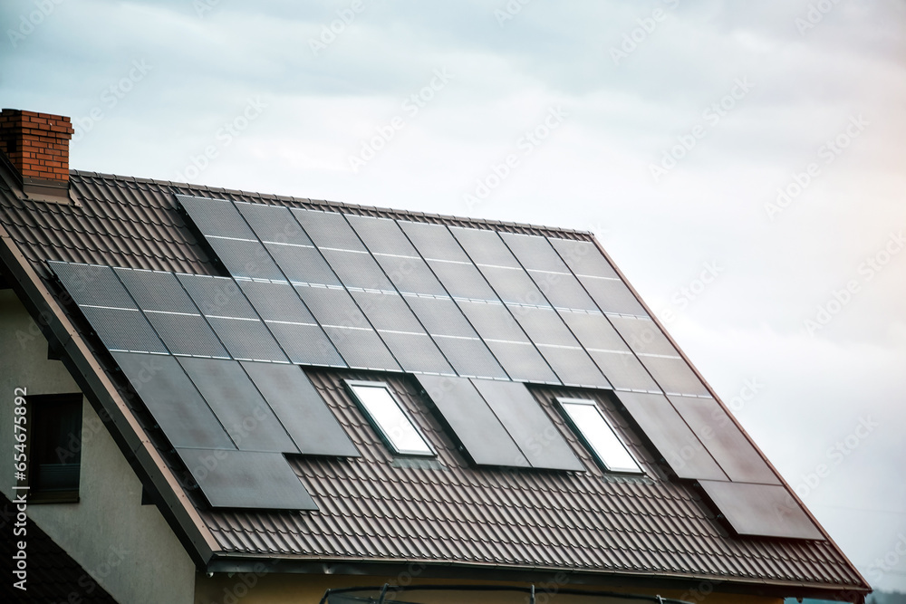 Fototapeta premium Solar Panels Powering a Sustainable Future. Modern Home with Photovoltaic Panels.