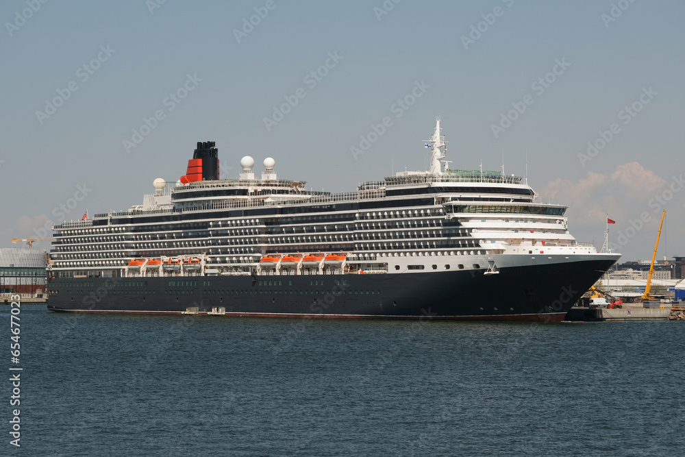 Luxury British ocean liner cruiseship cruise ship in port of Helsinki, Finland during Baltic cruising with city skyline	