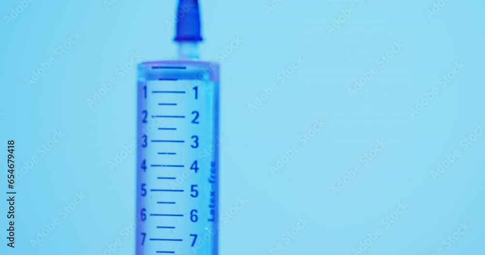 Video of laboratory syringe with copy space on blue background Video of laboratory syringe with copy space on blue background