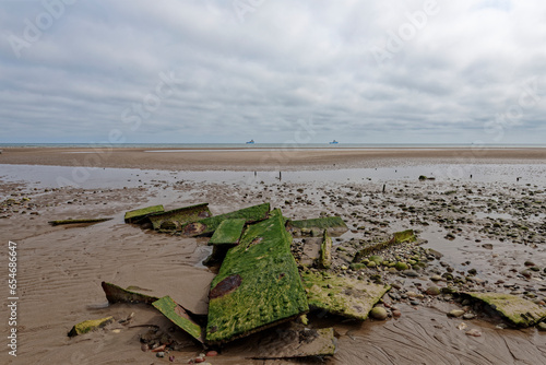 The metal plates and debris covered in Marine growth of an old Ship Wreck at the northern end of Montrose beach near to a shallow channel. photo