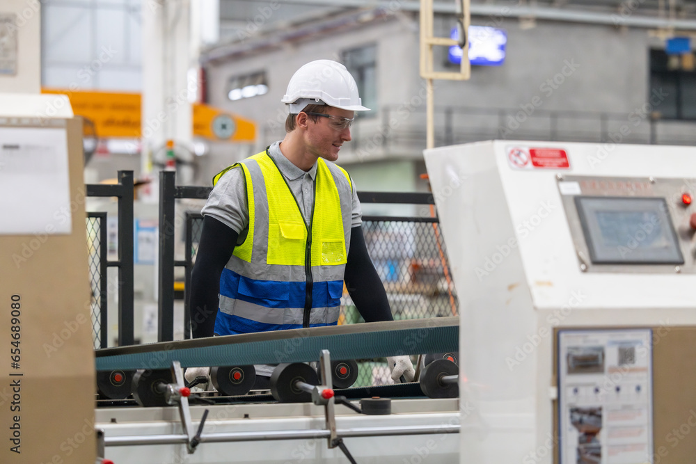 Technician ensures machinery stays regular, inspect error for smooth operations in cardboard factory Technician ensures machinery stays regular, inspect error for smooth operations in cardboard factory