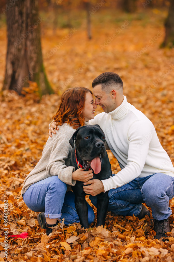 Young couple smiling happy and hugging dog at the park. Young couple smiling happy and hugging dog at the park.