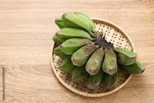 Raw Kepok Banana (Pisang Kepok) on wooden table
 photo