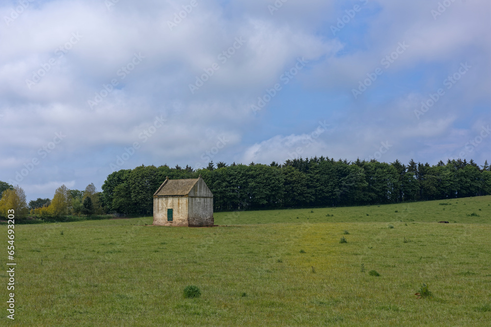 An Old Estate Stone Dovecot used to house Pigeons set in the middle of a Grassy Field in Farmland close to Montrose in Aberdeenshire. An Old Estate Stone Dovecot used to house Pigeons set in the middle of a Grassy Field in Farmland close to Montrose in Aberdeenshire.