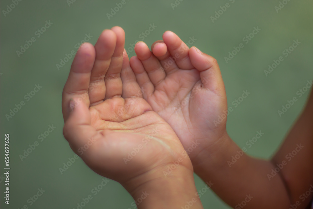 A boy praying and blurred light background A boy praying and blurred light background
