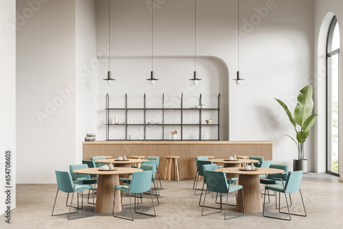 White cafe interior with bar and tables