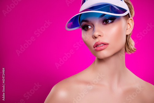 Photo of attractive lady wear plastic transparent visor cap look empty space advertising on pink background